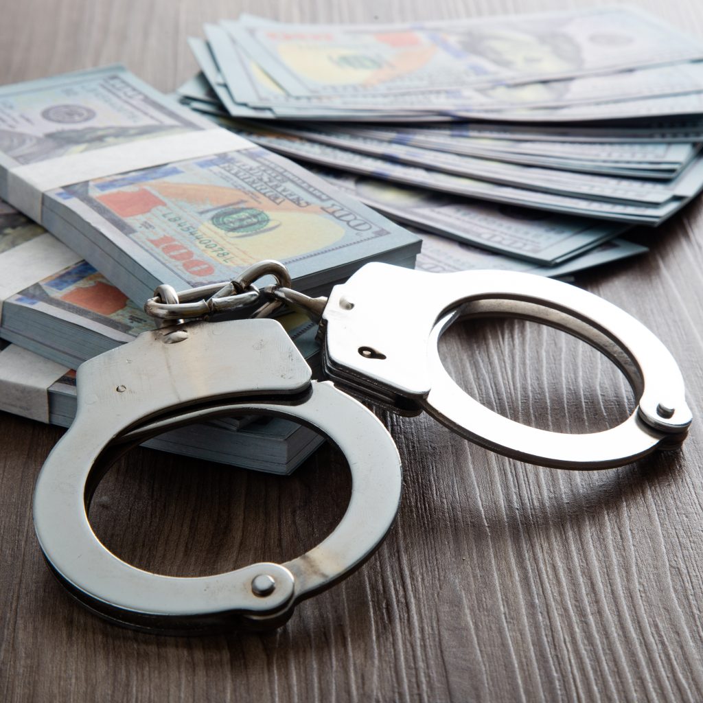 Money and handcuffs. Concept for corruption, fraud and money laundry
