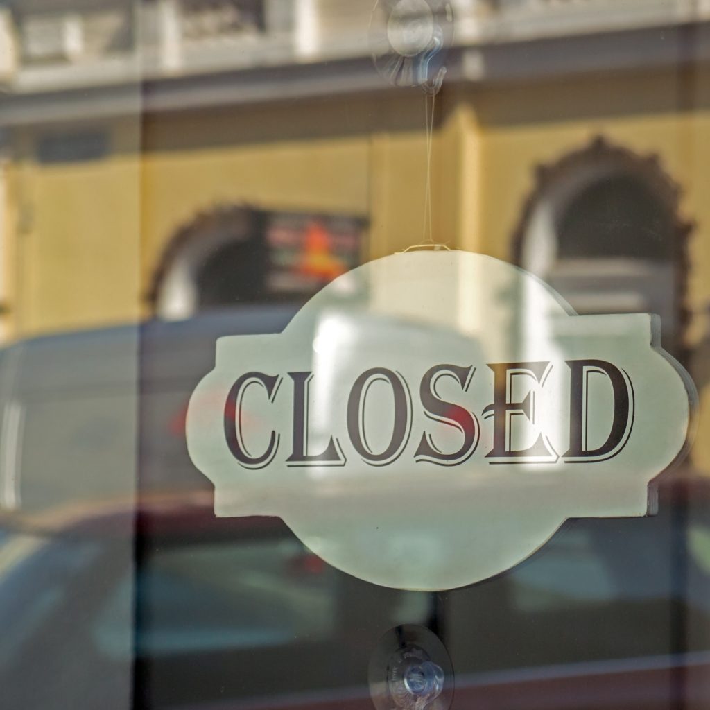 Closed sign on store glass window