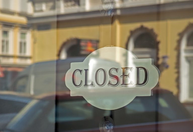 Closed sign on store glass window